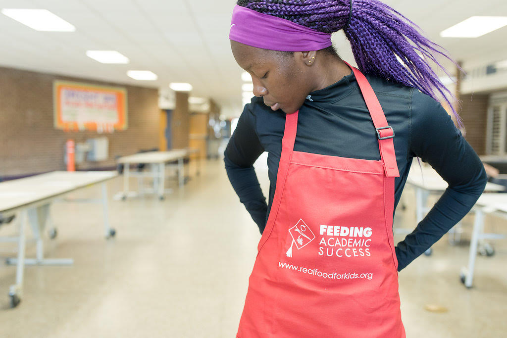 Woman putting on an apron