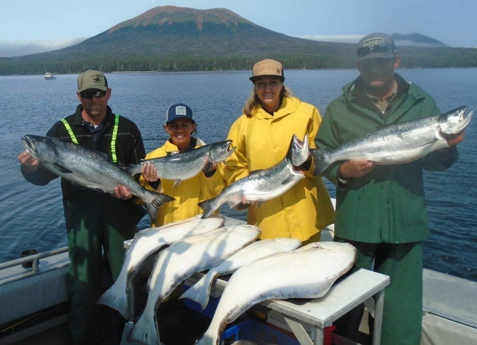 Angling Unlimited guests hold salmon and halibut
