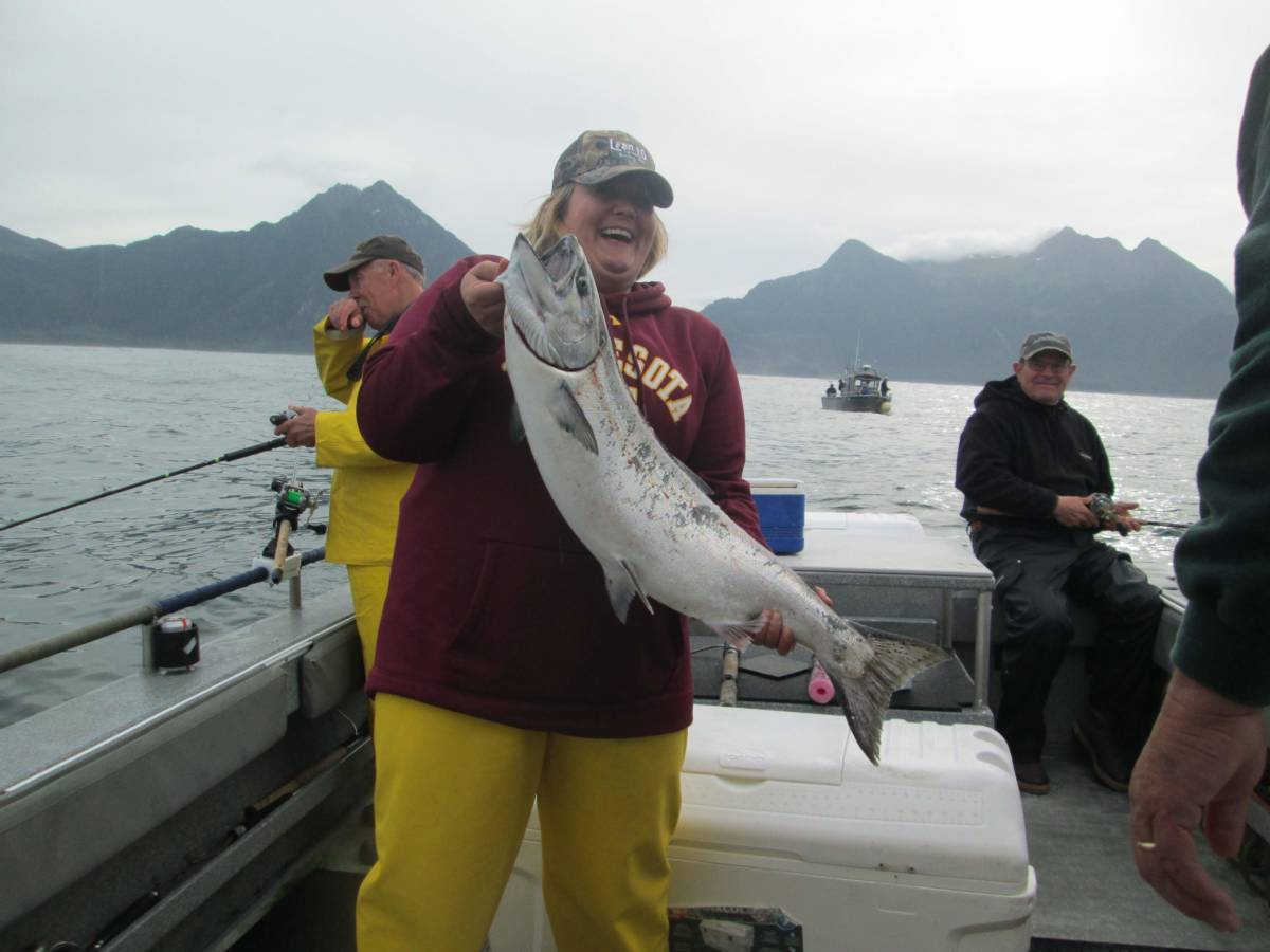 Angling Unlimited guest holds a salmon