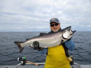 Stewart Evers man holding large king salmon on boat