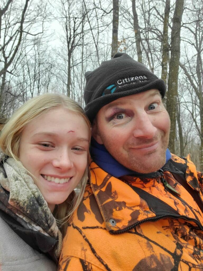 Man and women smile in camo clothing
