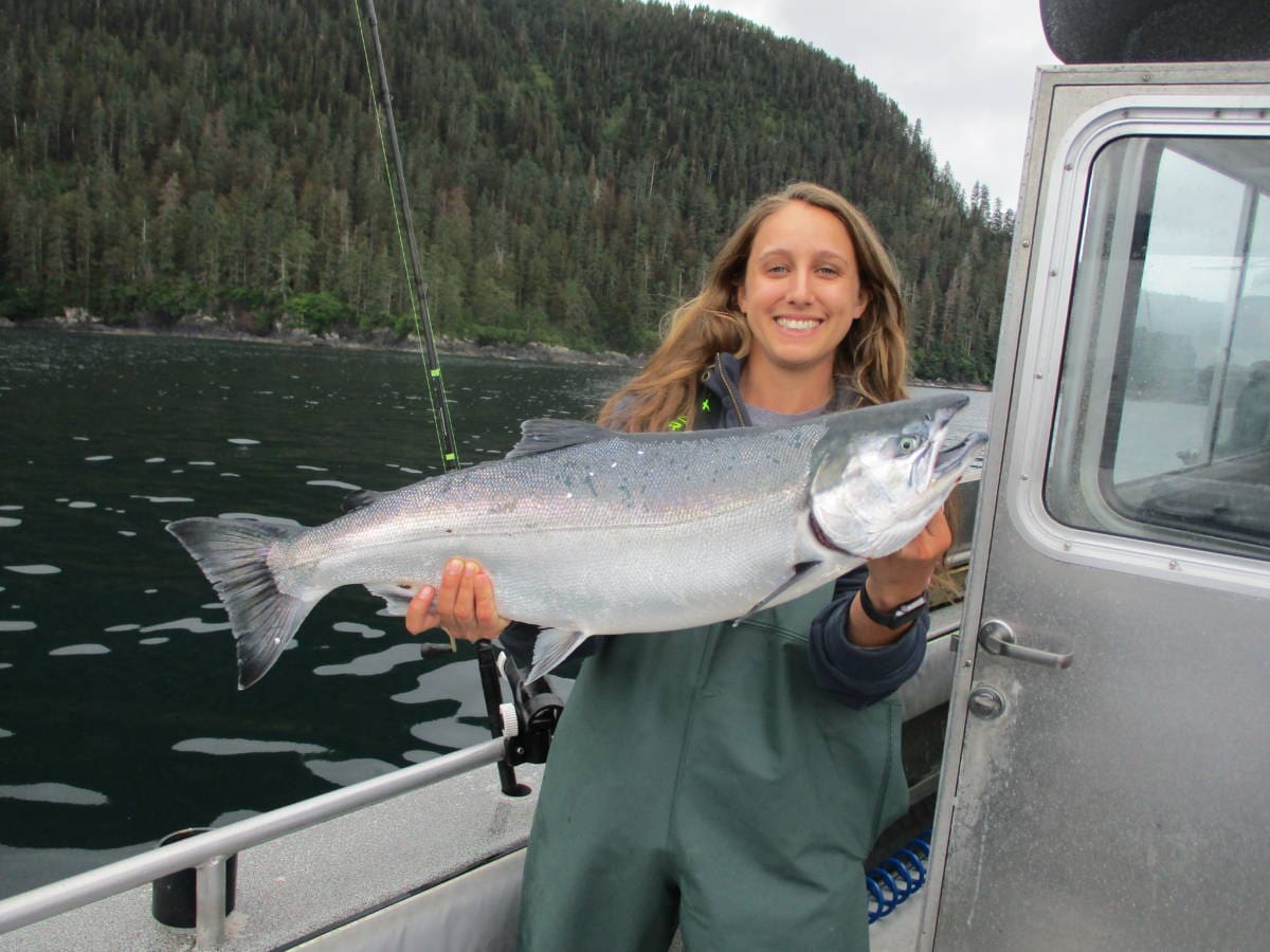 Angling Unlimited guest holds up a king salmon