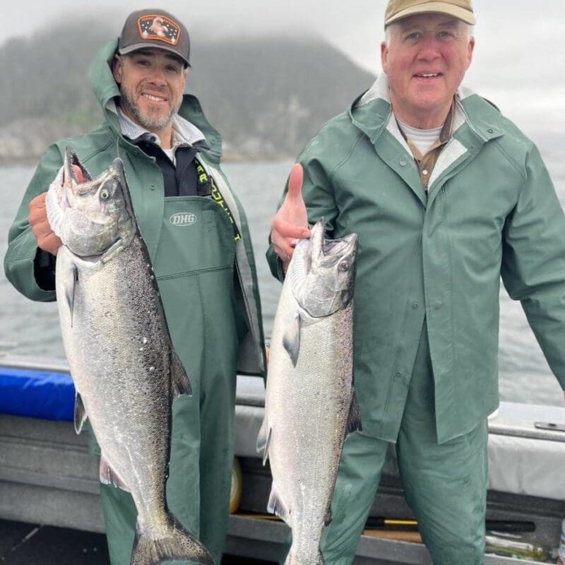 Men holding salmon