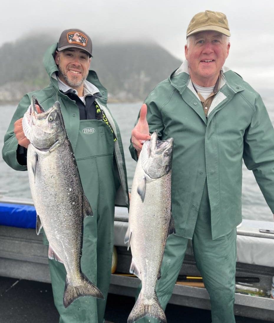 Men holding salmon