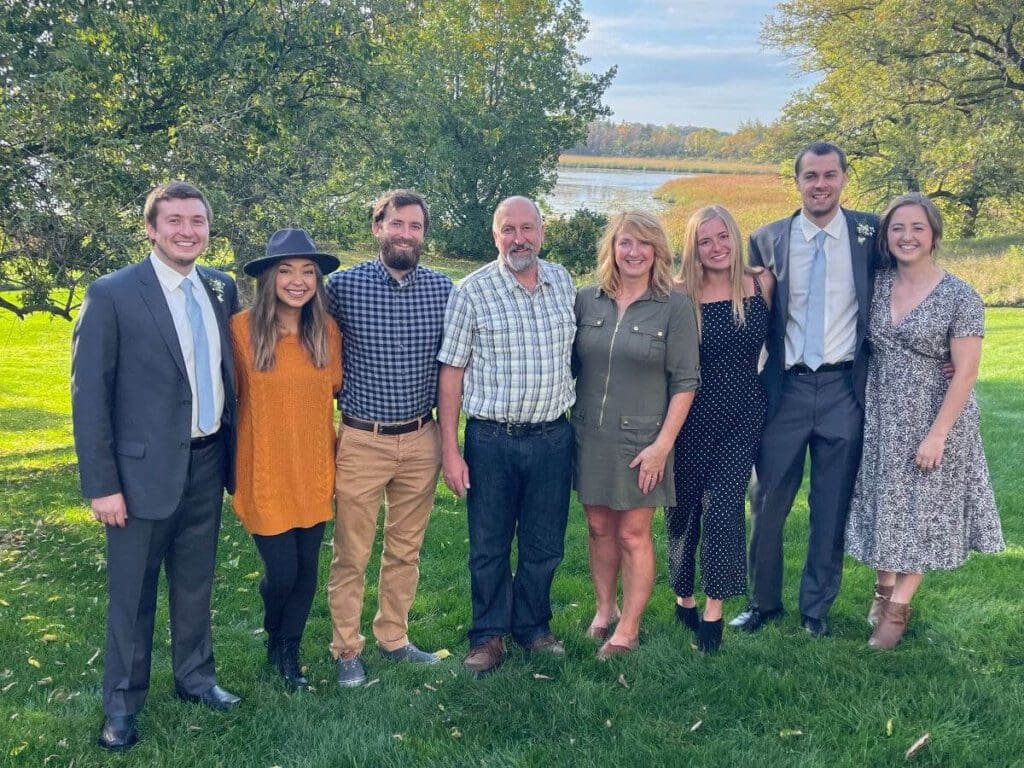 Family stands on the grass outside
