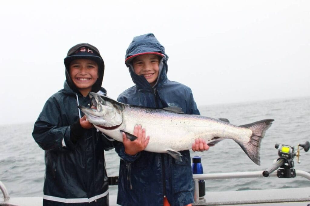IMG_3402_Original Large Two kids hold a king salmon on a boat in Sitka, Alaska