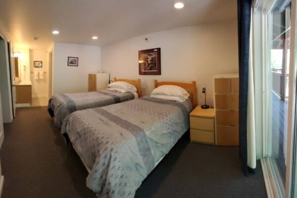 Bedroom and balcony of a waterview suite in Sitka, Alaska