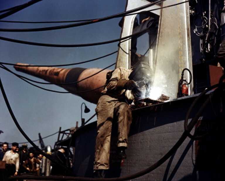 A welder constructs the face of one of IOWA's 16 inch gun turrets. October 1942 - 80-G-K-509 also 80-G-K-512 picture number 1