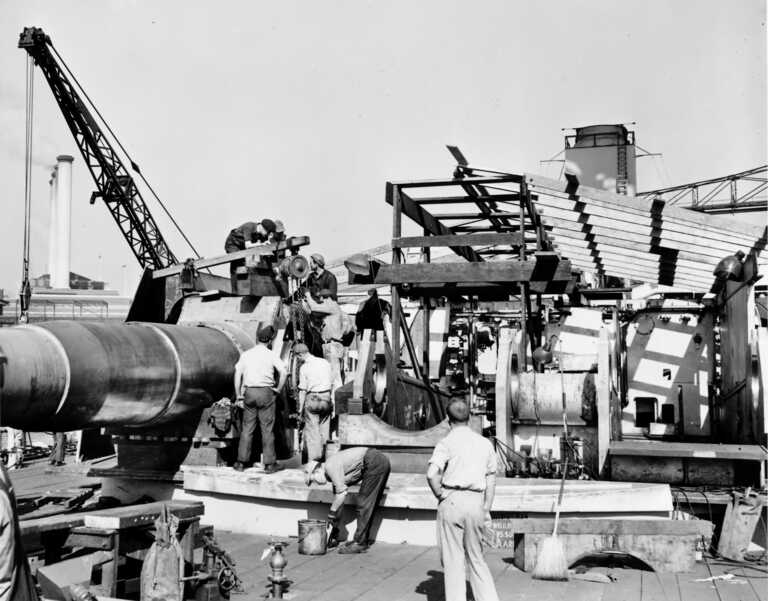 USS Iowa's forward Main Deck - shipyard workers install one of the 16 inch Mark 7 gun barrels in Turret 1. Fall 1942 - 80-G-K-507 picture number 1