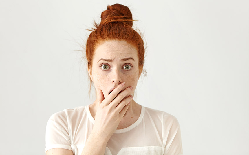 surprised covering mouth woman redhead adobe