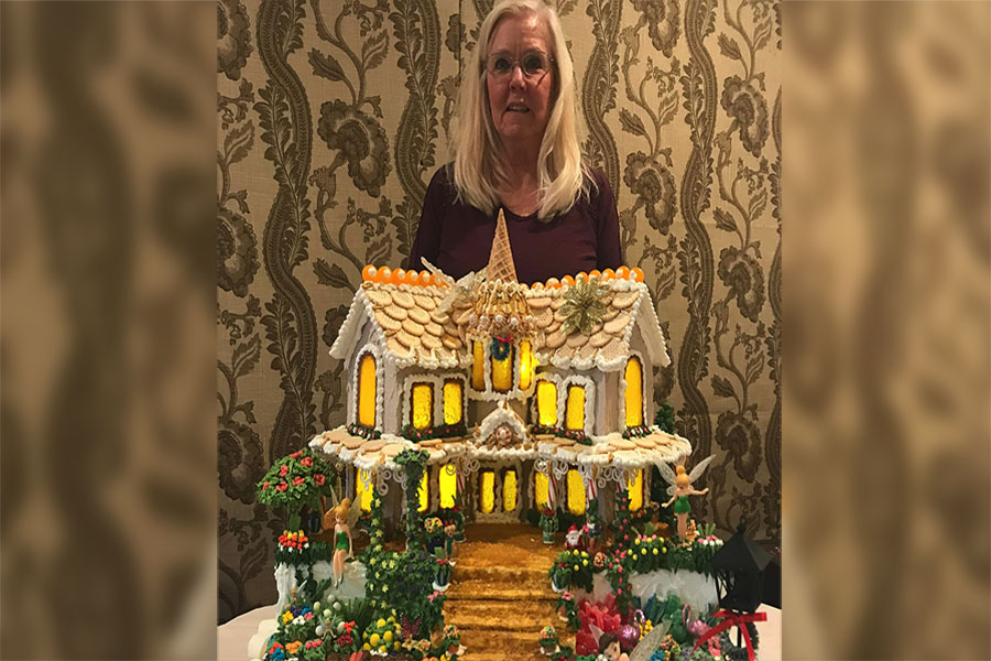 Geri Hansen with her gingerbread house