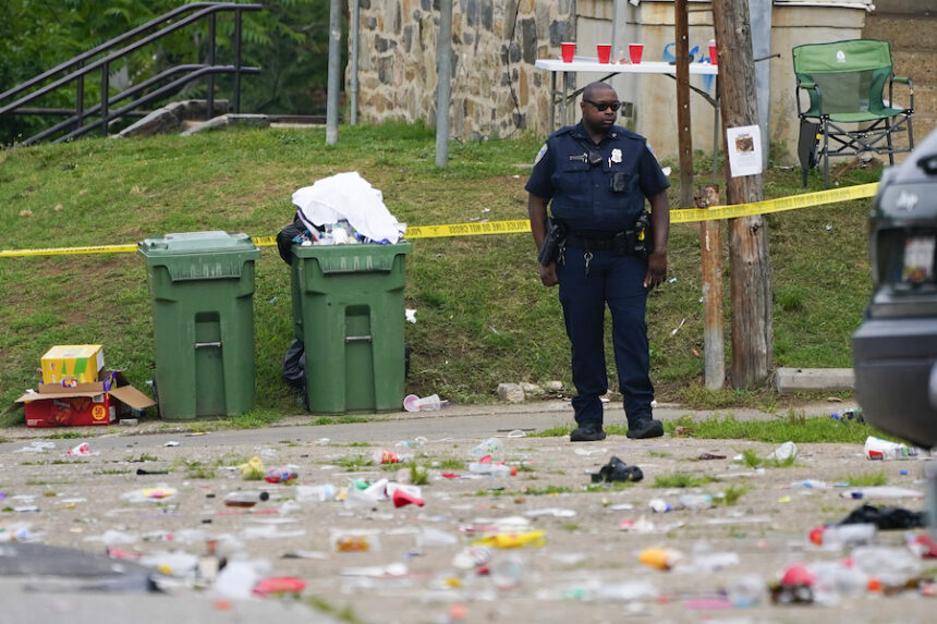 A police officer stands in the area of a mass shooting incident