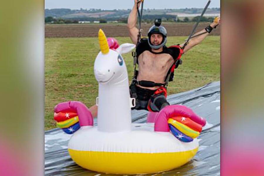 WATCH: Skydiver lands, rides inflatable unicorn