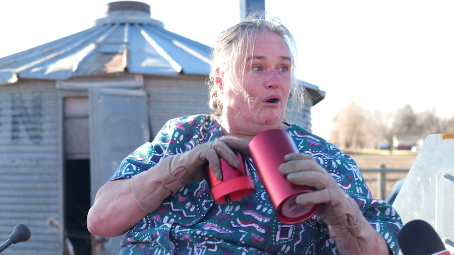 A woman working on her tractor gets the surprise of a lifetime from a Secret Santa