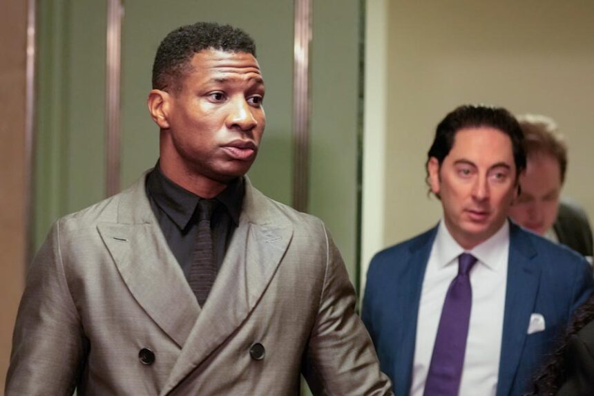 Jonathan Majors, left, enters a courtroom at the Manhattan criminal courts in New York, Monday, Dec. 18, 2023. The actor is accused of assaulting his then-girlfriend as the two struggled over a phone in the back seat of a chauffeured car. | Seth Wenig, Associated Press
