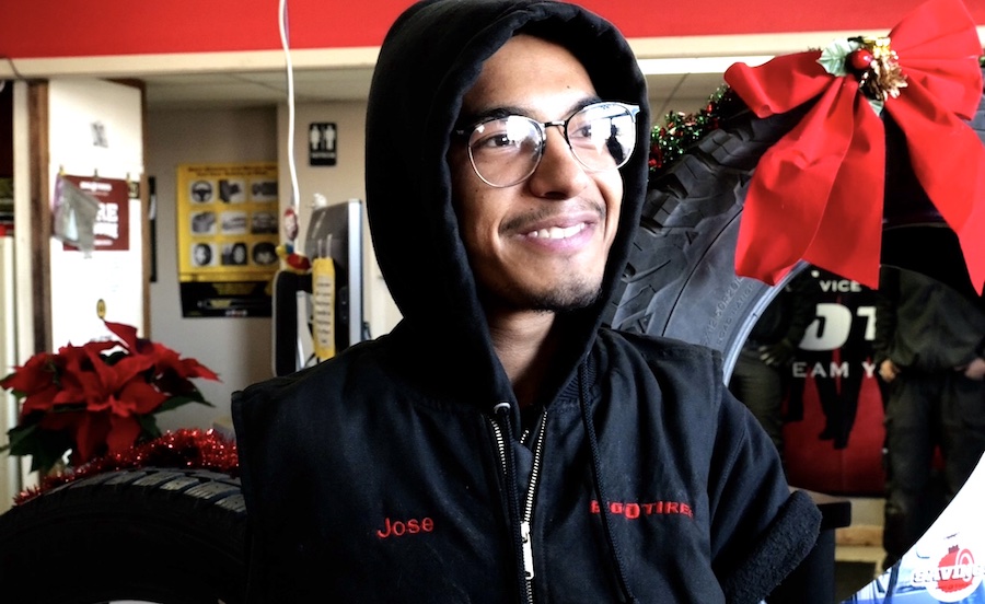 Man born without arms gets a Secret Santa surprise while working at the front desk of a tire store