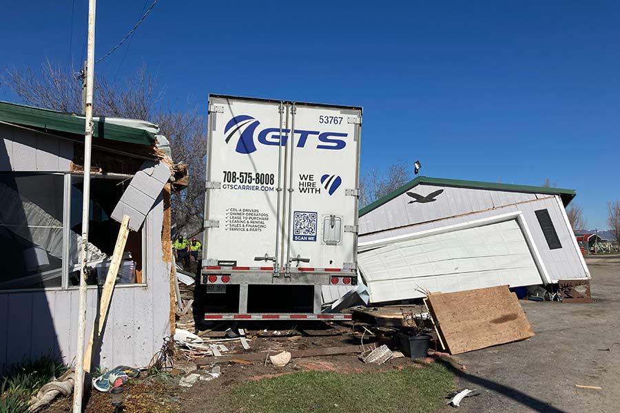 Semitruck crash narrowly misses home; destroys adjacent garage