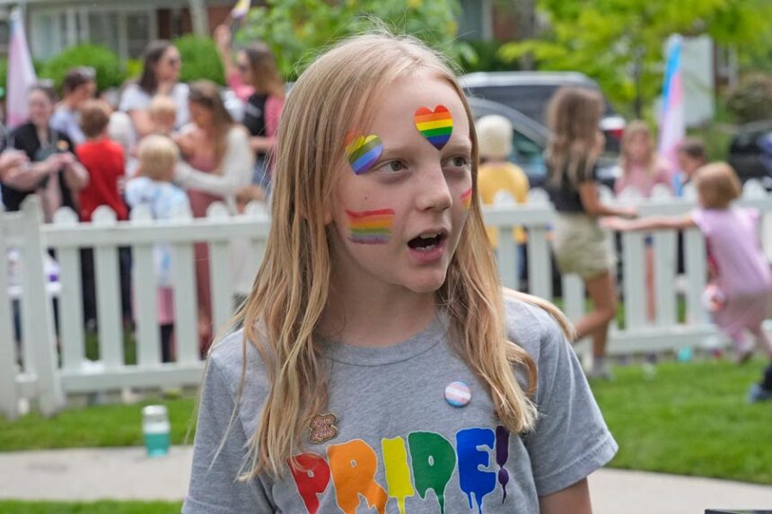 Bonneville Elementary School 5th grader Graham Beeton, is interviewed during a block party supporting trans and non binary students and staff Monday, April 29, 2024, in Salt Lake City. Utah will become the latest state to implement restrictions for transgender people using school bathrooms and locker rooms in public schools and government-owned buildings when key components of a law passed by the Republican controlled Legislature take effect May 1. (AP Photo/Rick Bowmer)