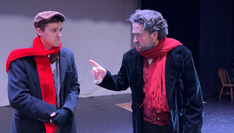 Man on stage pointing a finger at another man