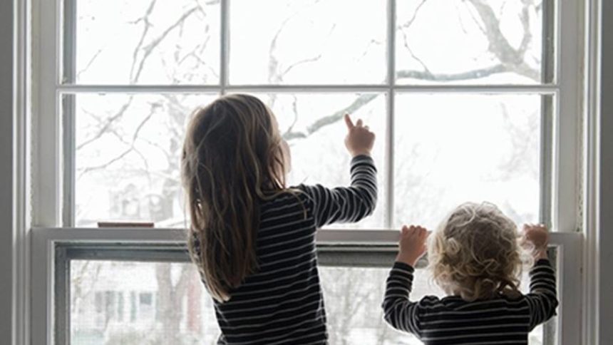 Children looking out a window
