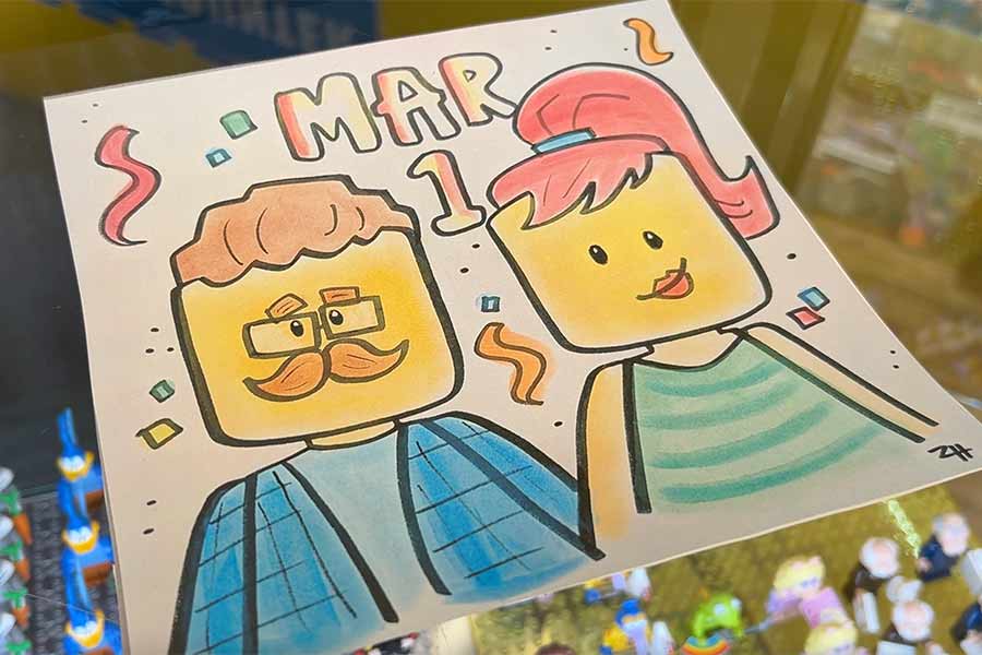 Local artist drawing LEGO caricatures for customers during shop’s 1 year anniversary