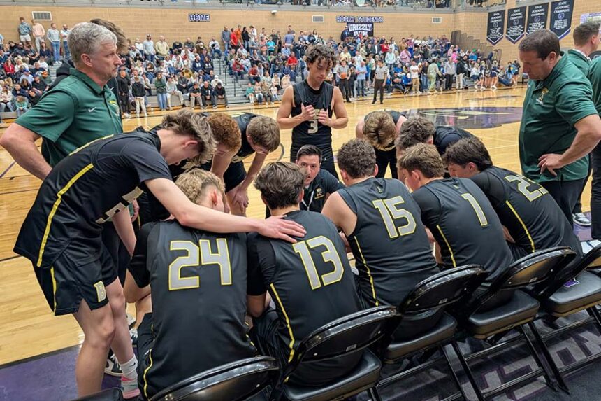 Head coach Cortland Hengel leads the Bonneville huddle before the start of the fourth quarter against Middleton.