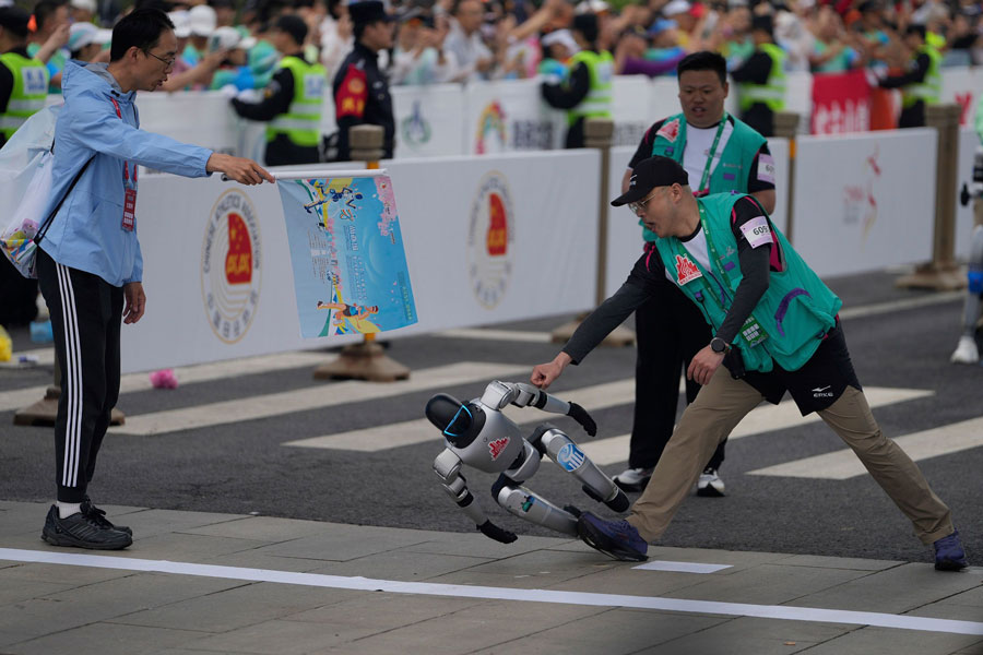 A robot loses control at the start of what is billed as the world's first robot half marathon in Beijing, China, on Saturday, April 19.