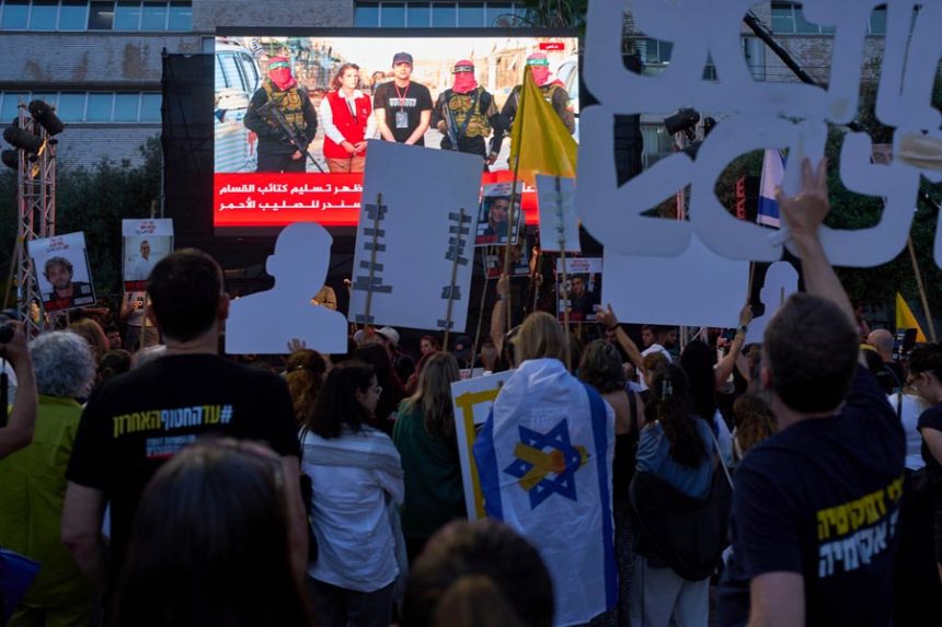People watch a live broadcast of Israeli-American soldier Edan Alexander as he is released from Hamas captivity in Gaza, at a plaza known as the hostages square in Tel Aviv, Monday, May 12, 2025. Alexander was abducted during the Hamas-led attack on his base on October 7, 2023. | Oded Balilty, Associated Press