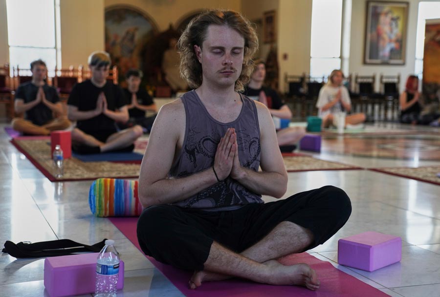 Gavin Bartholomew attends a 90-minute yoga class at Shri Shri Radha Krishna Temple in Spanish Fork, Utah, on Wednesday, April 23, 2025. (AP Photo/Jessie Wardarski)