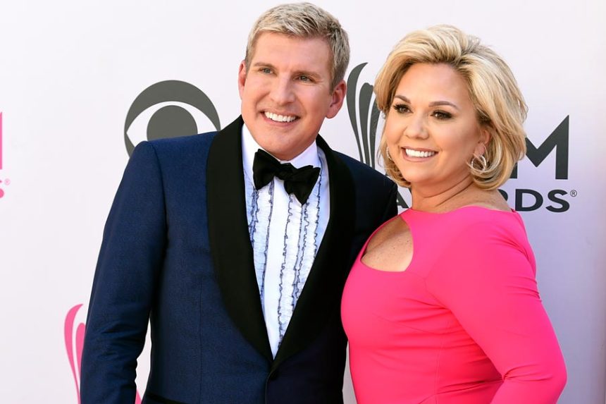 Julie Chrisley, right, and her husband Todd Chrisley pose for photos at the 52nd annual Academy of Country Music Awards April 2, 2017, in Las Vegas. | Jordan Strauss, Invision via Associated Press