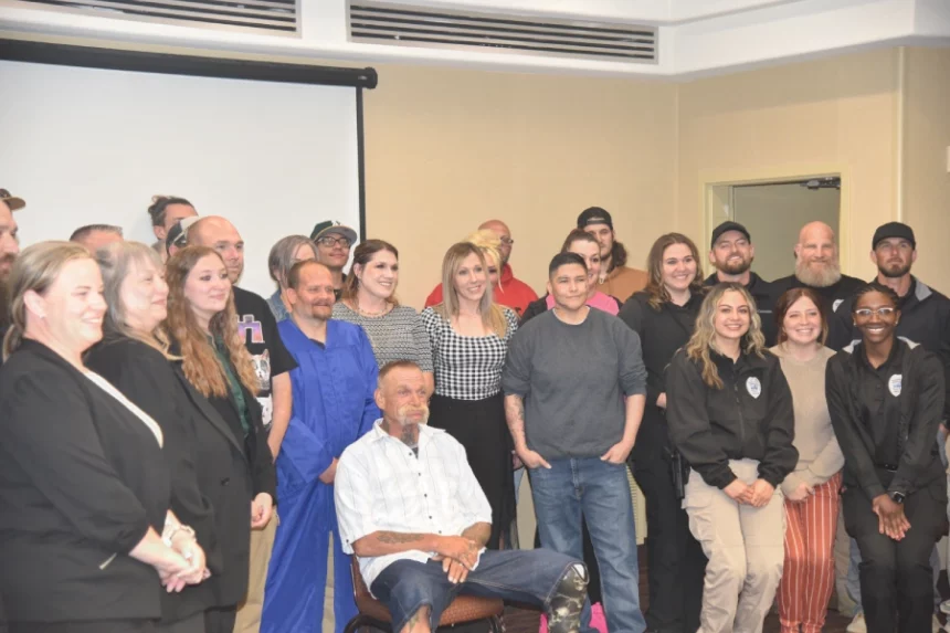 Parolees and staff gather for a group photo