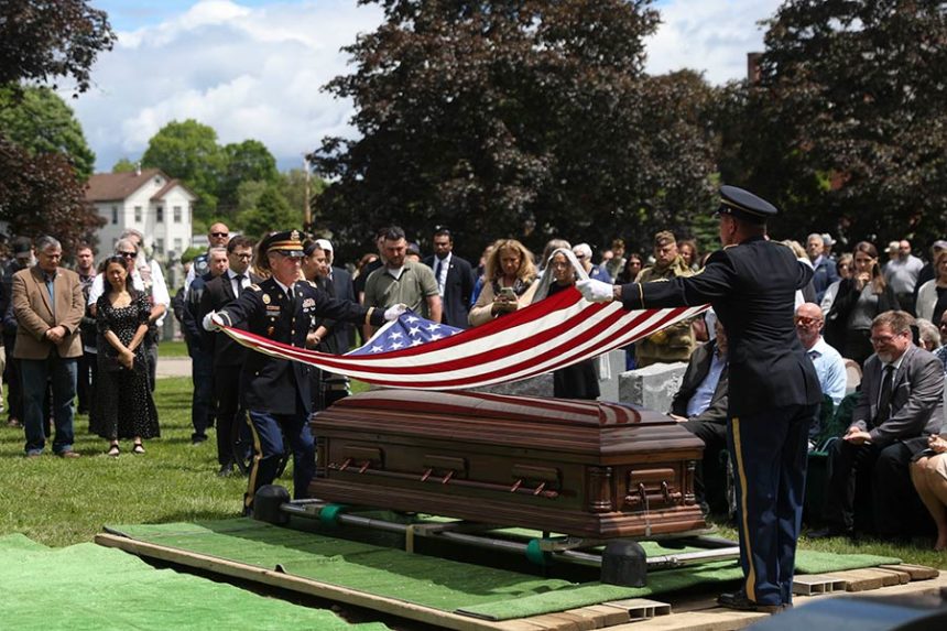 An American flag is folded during the interment for World War II U.S. Army Air Forces Staff Sgt. Eugene Darrigan at the cemetery behind St. Mary's church, Saturday, May 24, 2025, in Wappingers Falls, N.Y. Darrigan was buried in his hometown after his remains were recovered from a World War II bomber that crashed into the water off the coast of New Guinea on March 11, 1944. (AP Photo/Heather Khalifa)