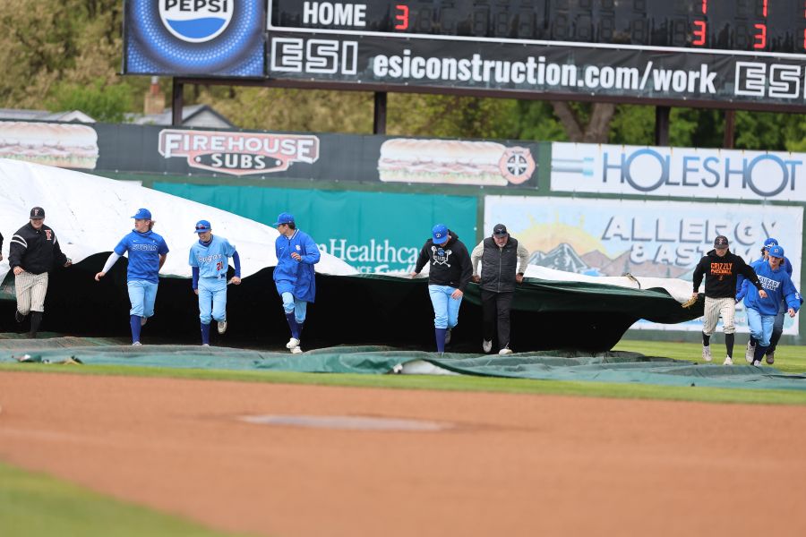 Players from both Sugar-Salem and Fruitland help the ground crew remove the tarp during Saturday's 4A State Championship Baseball Game. | Courtesy photo.