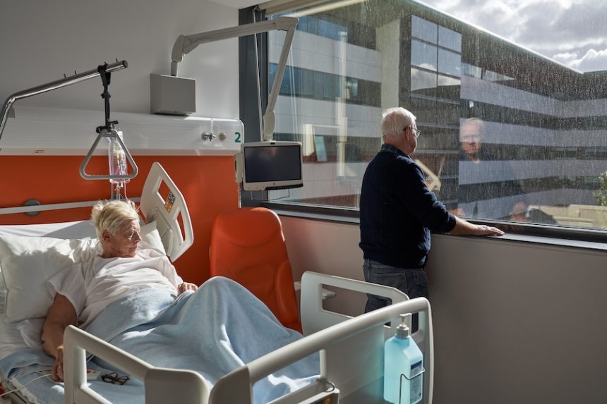 thoughtful elderly man standing near window during 2025 04 04 07 09 54 utc