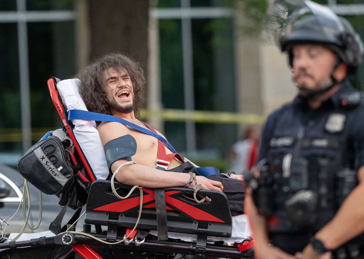 Arturo Gamboa, 24, is taken away in handcuffs on a gurney and yells that he was shot during the “No Kings” protest and march in Salt Lake City on Saturday. | Scott G Winterton, Deseret News