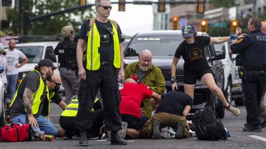 People rush to give medical assistance to a man shot during a “No Kings” protest in Salt Lake City Saturday. A group who helped organize the rally says the "peacekeeper;" who shot and killed a bystander was a "safety volunteer;" and military veteran. | Brice Tucker, Deseret News