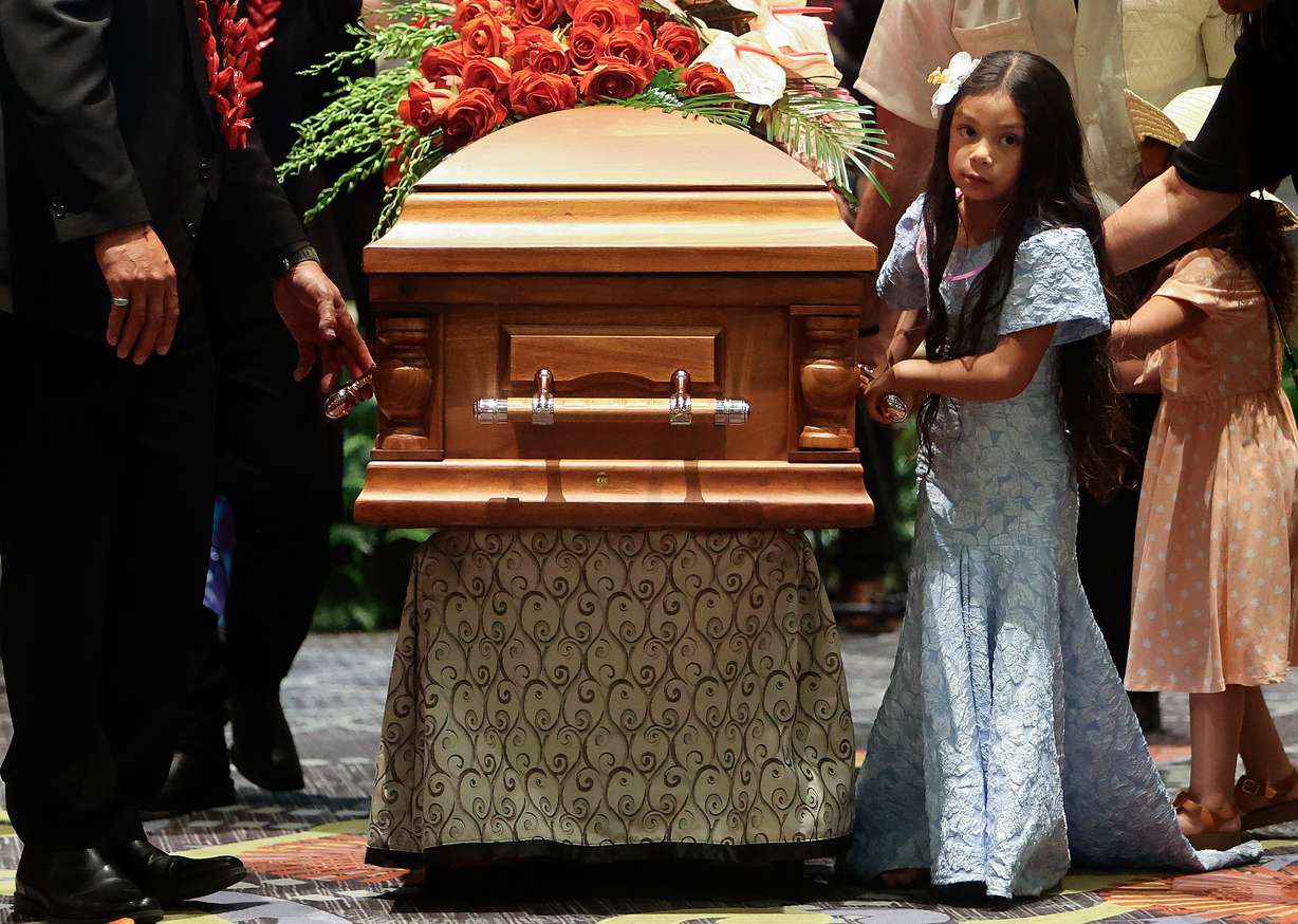 Vera Ah Loo walks with her father Afa Ah Loo’s casket at the end of his celebration of life at the Salt Palace Convention Center in Salt Lake City on Friday. Afa was shot and killed as an innocent bystander during a No Kings protest. | Kristen Murphy, Deseret News