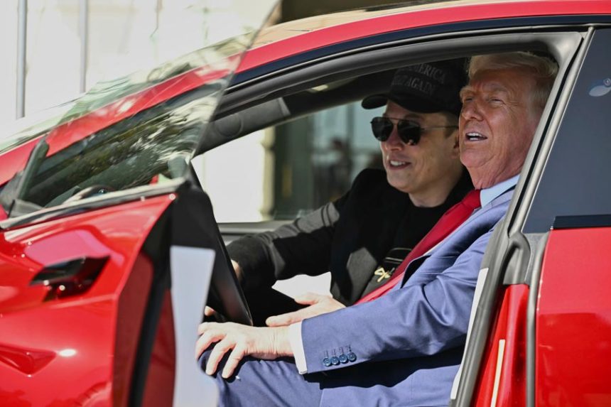 President Donald Trump and Tesla CEO Elon Musk speak to reporters as they sit in a red Model S Tesla vehicle on the South Lawn of the White House, March 11, 2025, in Washington. | Associated Press