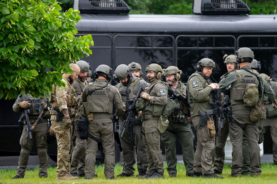 Law enforcement officers including local police, sheriffs and the FBI, stage less than a mile from a shooting in Brooklyn Park, Minn. on Saturday, June 14, 2025. | Alex Kormann, Star Tribune via Associated Press