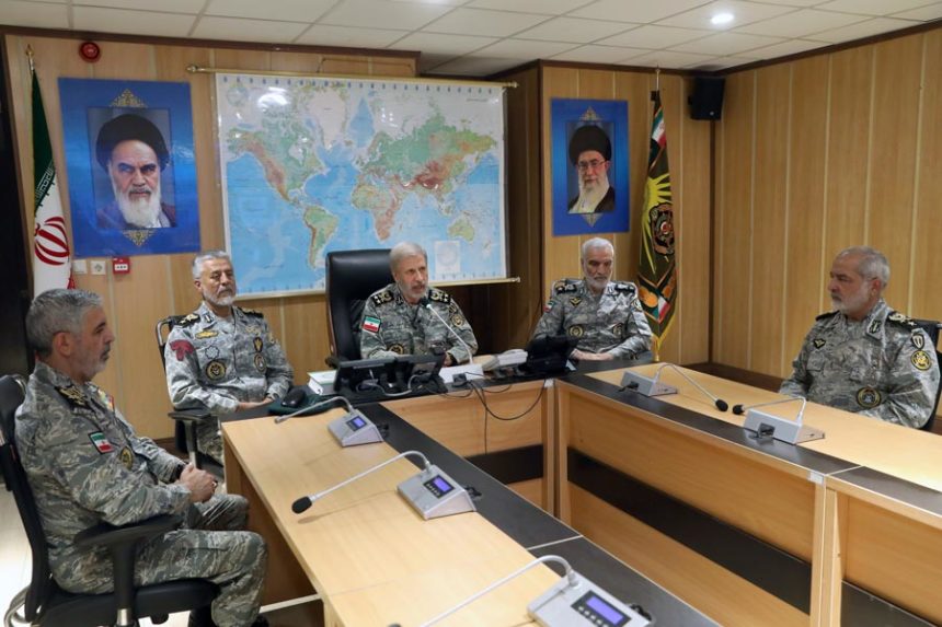 In this photo released on Monday, June 23, 2025, by Iranian army press service, Iran's army commander-in-chief Gen. Amir Hatami, center, accompanied by high ranked army commanders, speaks in a video call with top commanders of the army, in Zolfaghar central headquarters, Iran, as portraits of the late revolutionary founder Ayatollah Khomeini, left, and Supreme Leader Ayatollah Ali Khamenei hang on the wall. | Iranian Army Press Service via Associated Press
