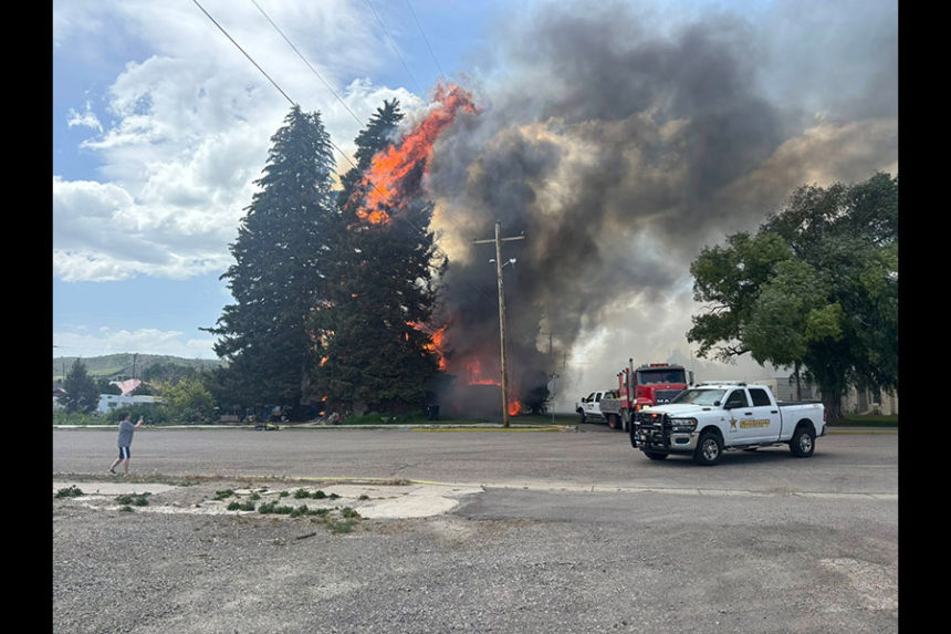 Flames engulfing a tree next to a residence in Bancroft. | The Idaho Enterprise in Caribou County