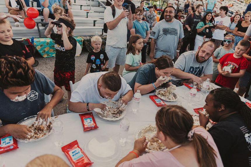 Community members participating in a pie eating contest during the Food Truck and Fireworks event in 2024 | Courtesy Top-Notch Real Estate