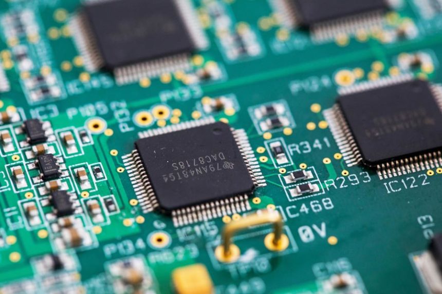 An integrated circuit microchip manufactured by Texas Instruments. The company pledged a major investment to expand US plants. | Chris Ratcliffe/Bloomberg/Getty Images via CNN Newsource