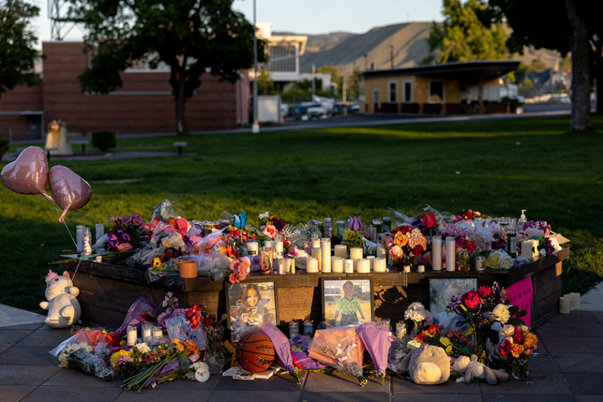 Pictures, flowers and candles mark a makeshift memorial Tuesday, June 3, 2025, in Wenatchee, Wash., in honor of Olivia, Paityn and Evelyn Decker, who were found dead near Leavenworth after their father Travis Decker failed to return them after a scheduled visitation. (Nick Wagner/The Seattle Times via AP)