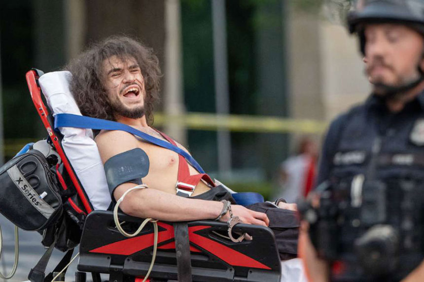 Arturo Gamboa is taken away in handcuffs on a gurney and yells that he was shot during the “No Kings” protest and march in Salt Lake City Saturday. A judge on Thursday agreed to release him from jail since no charges have been filed against him. (Scott G Winterton, Deseret News)