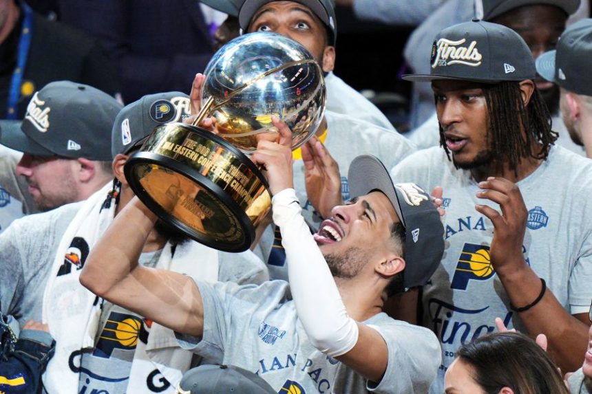 Indiana Pacers guard Tyrese Haliburton holds up the trophy after the Pacers won Game 6 of the Eastern Conference finals of the NBA basketball playoffs against the New York Knicks in Indianapolis, Saturday, May 31, 2025. (AP Photo/AJ Mast)