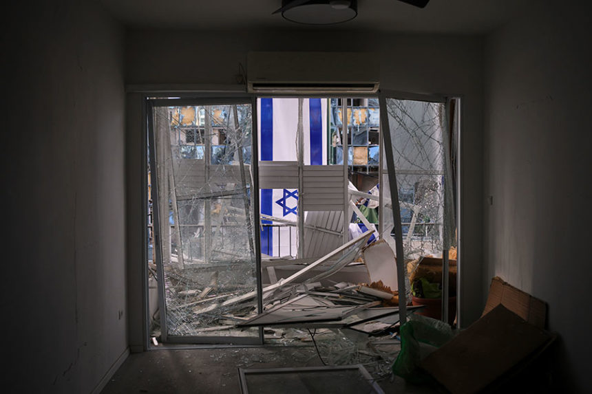 An Israeli flag is hung outside a damaged apartment two days after it was struck by a missile launched from Iran, in Ramat Gan, Israel, on Saturday, June 21, 2025. (AP Photo/Ohad Zwigenberg)