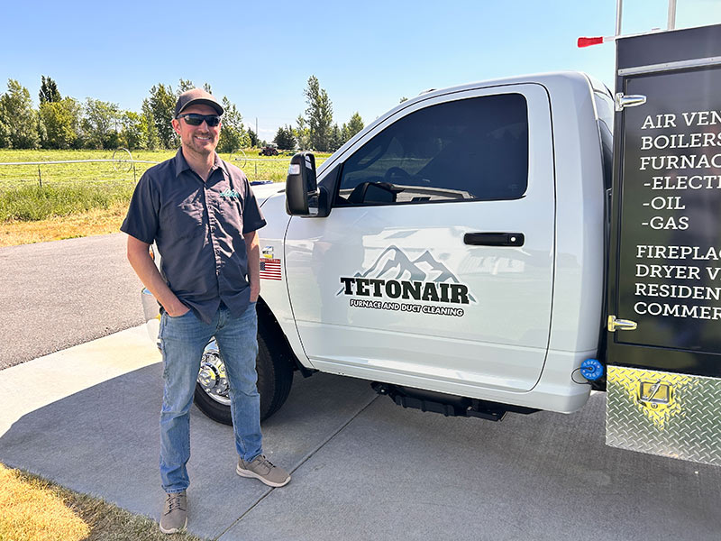 Jordan Graham poses for a photo at a customer's house in Hibbard. | Rett Nelson, EastIdahoNews.com