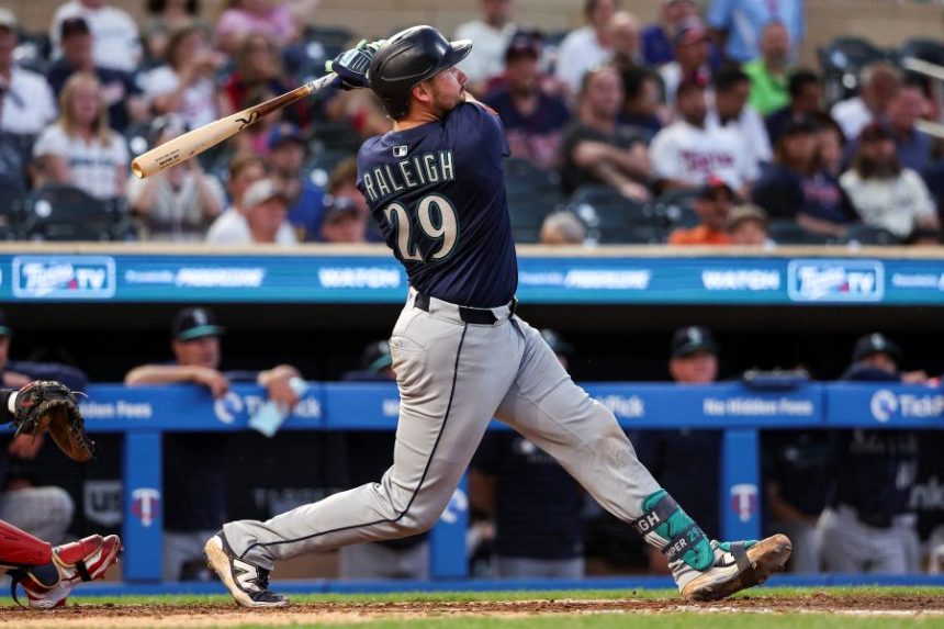 Seattle Mariners' Cal Raleigh hits a solo home run against the Minnesota Twins during the ninth inning of baseball game Monday, June 23, 2025, in Minneapolis. (AP Photo/Matt Krohn)