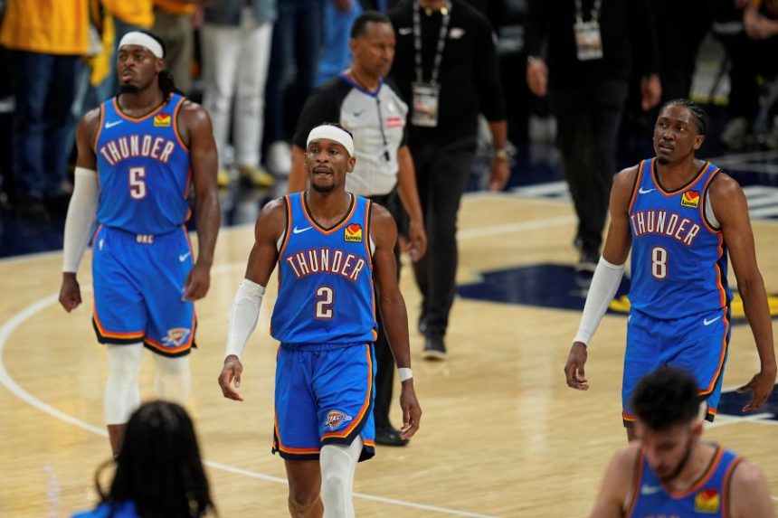 Oklahoma City Thunder guard Shai Gilgeous-Alexander (2), guard Luguentz Dort (5) and forward Jalen Williams (8) walk the their bench during the second half of Game 3 of the NBA Finals basketball series against the Indiana Pacers, Wednesday, June 11, 2025, in Indianapolis. (AP Photo/Abbie Parr)